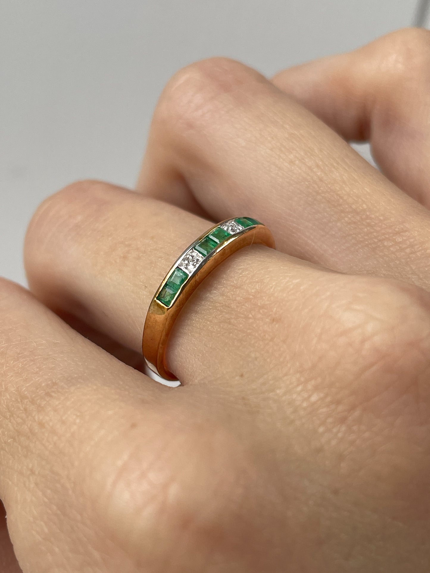 Vintage emerald and diamond half eternity ring