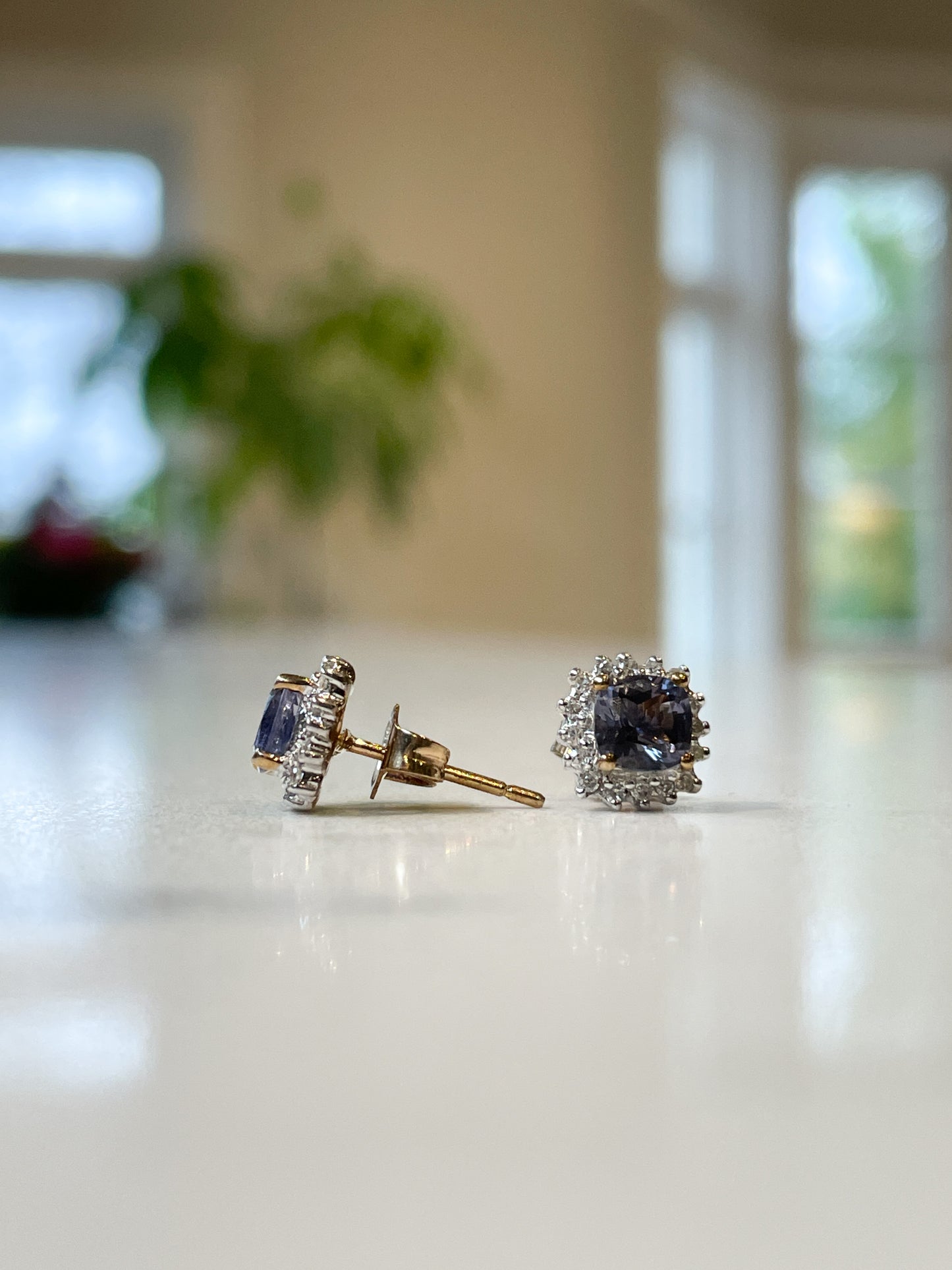 Tanzanite and diamond halo stud earrings on 9ct gold
