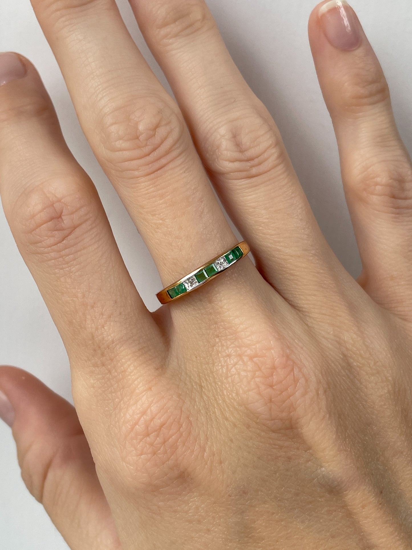 Vintage emerald and diamond half eternity ring