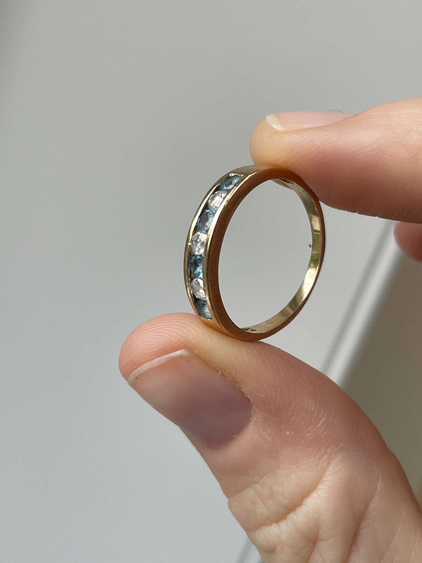 Blue topaz and diamond half eternity ring