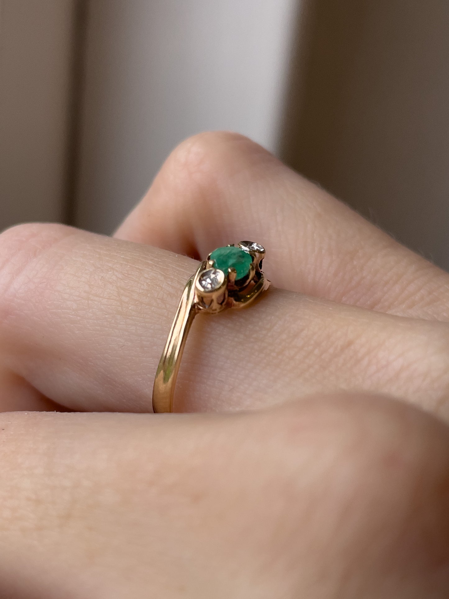 A vintage emerald and diamond trilogy ring on 9ct gold