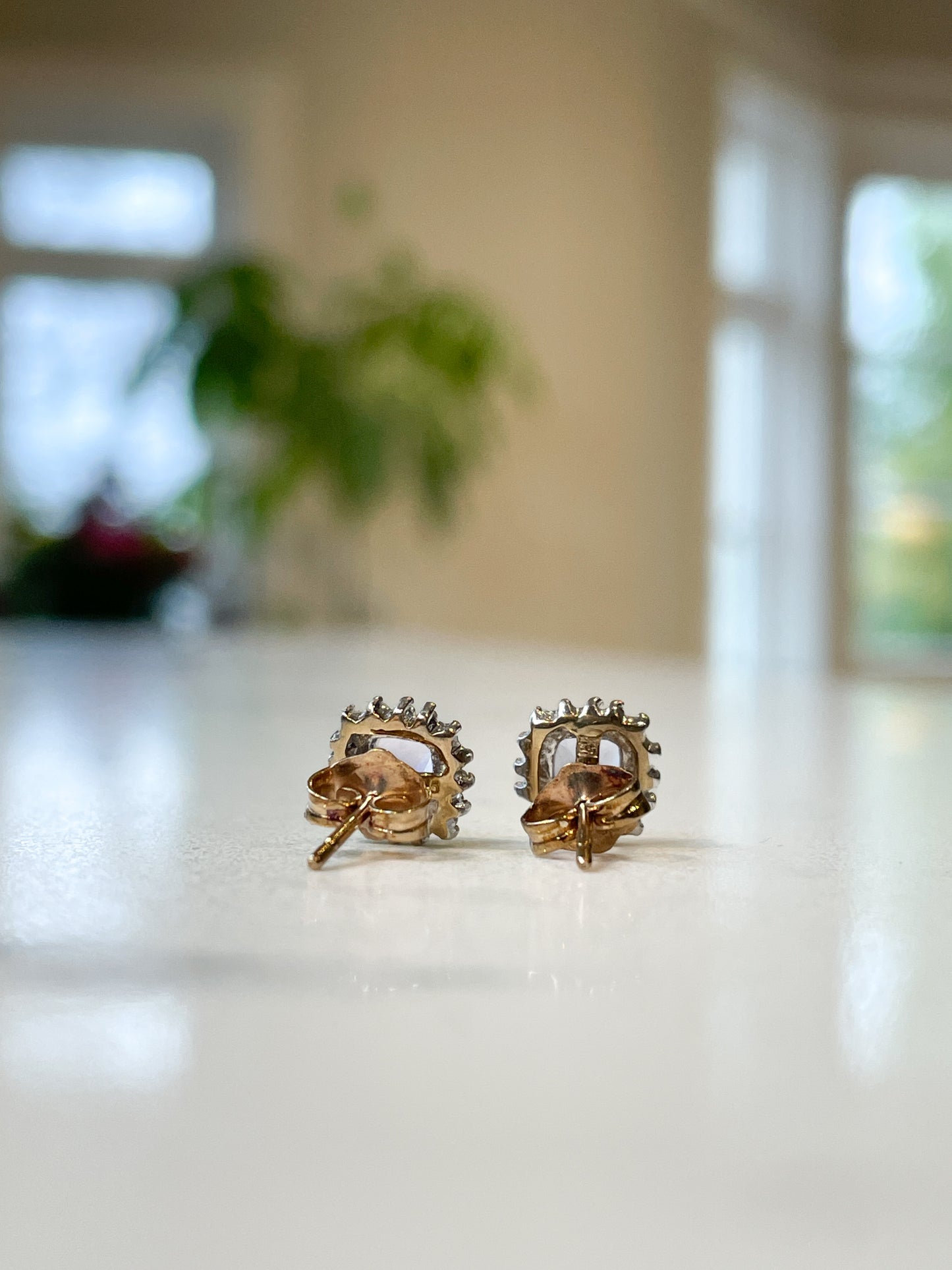 Tanzanite and diamond halo stud earrings on 9ct gold