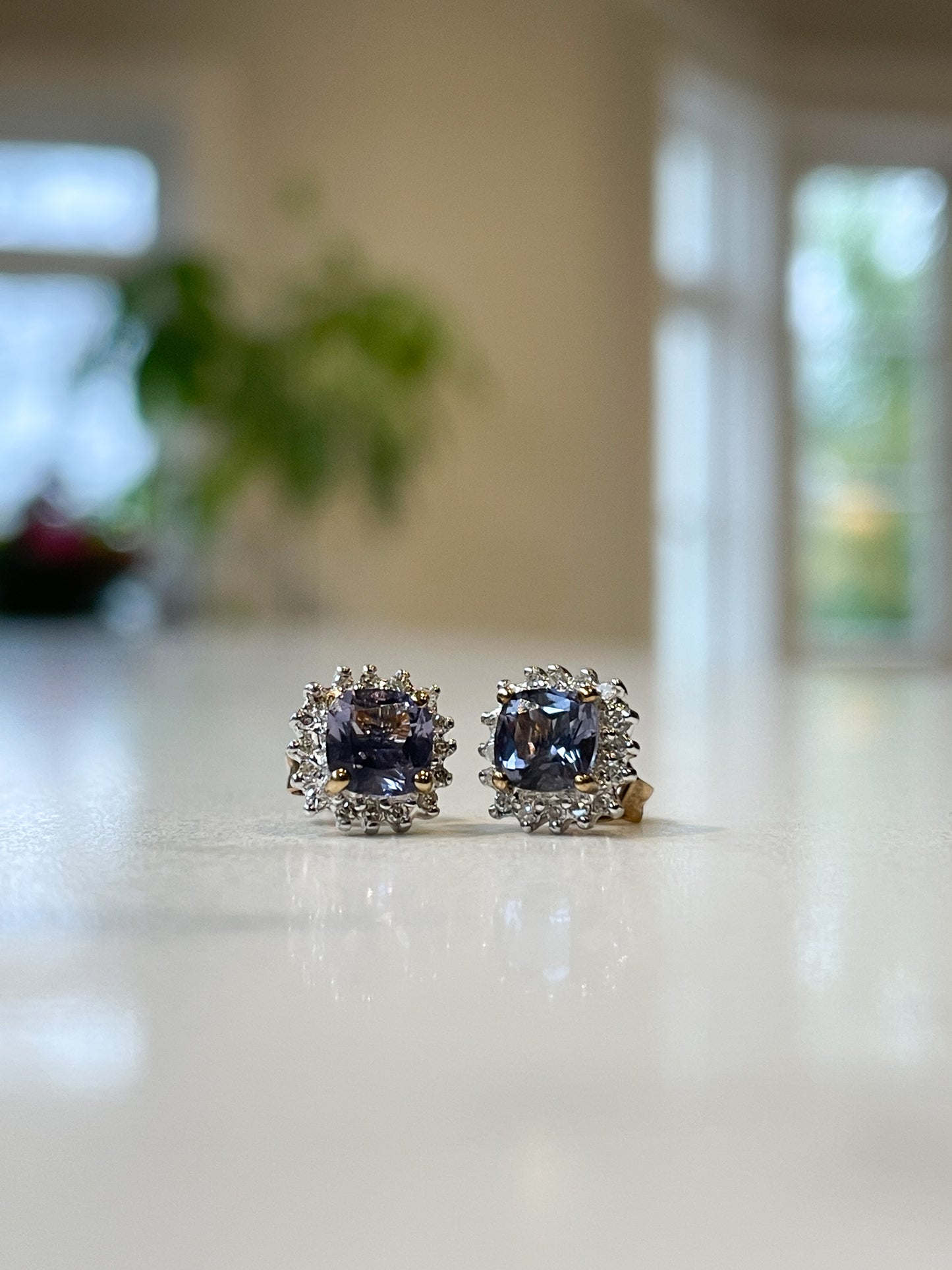 Tanzanite and diamond halo stud earrings on 9ct gold