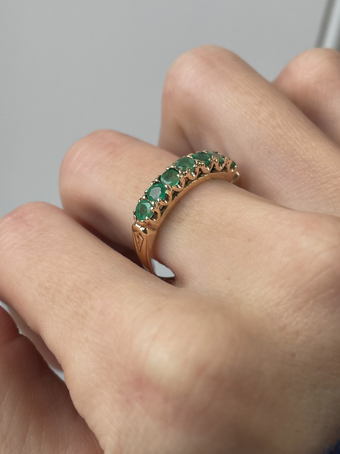 Vintage 7-stone emerald half eternity ring on 9ct gold