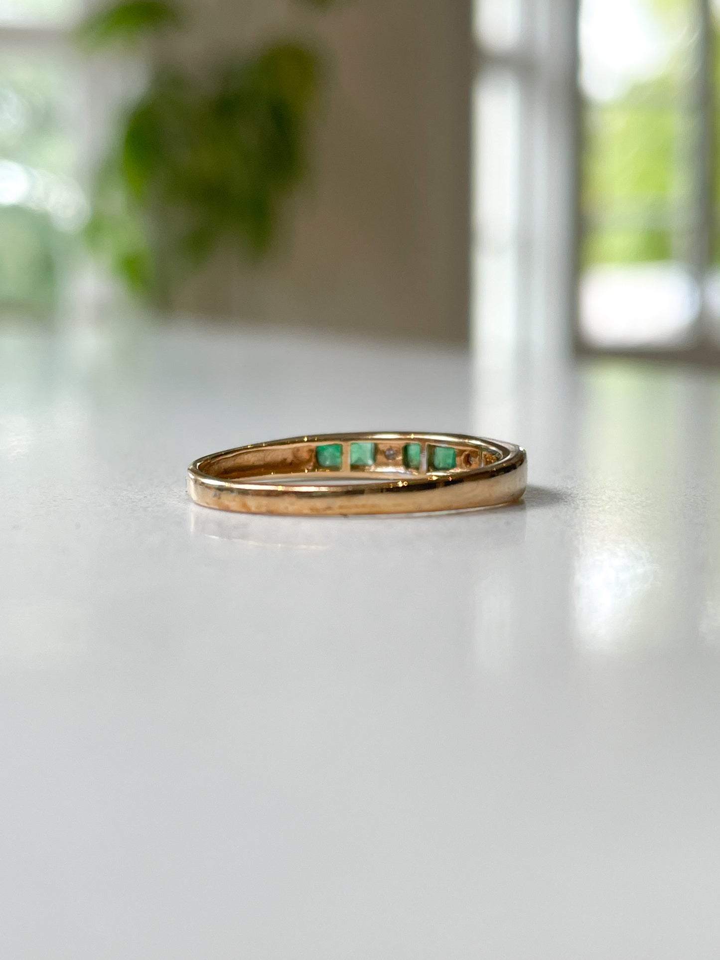 Vintage emerald and diamond half eternity ring