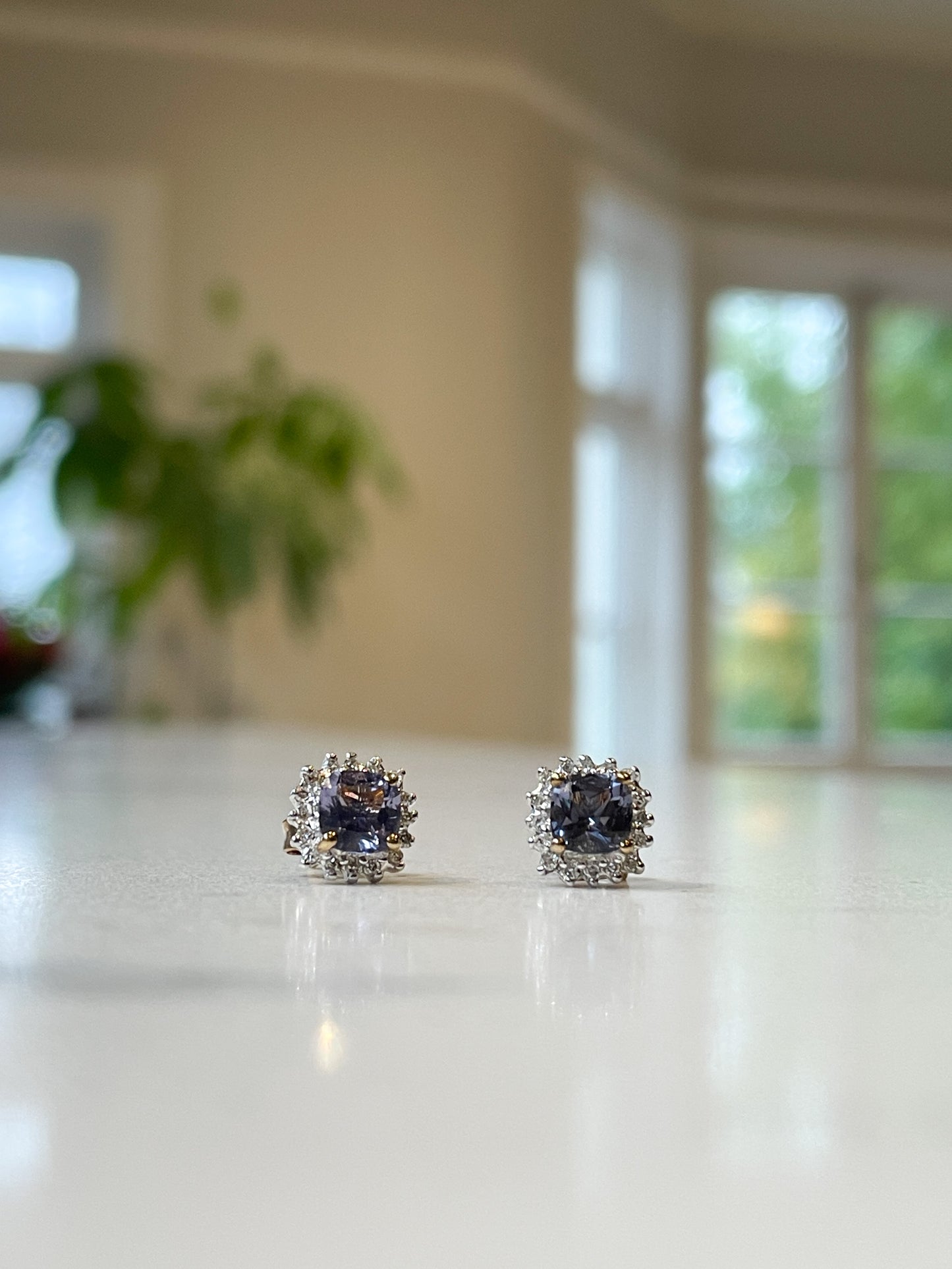 Tanzanite and diamond halo stud earrings on 9ct gold