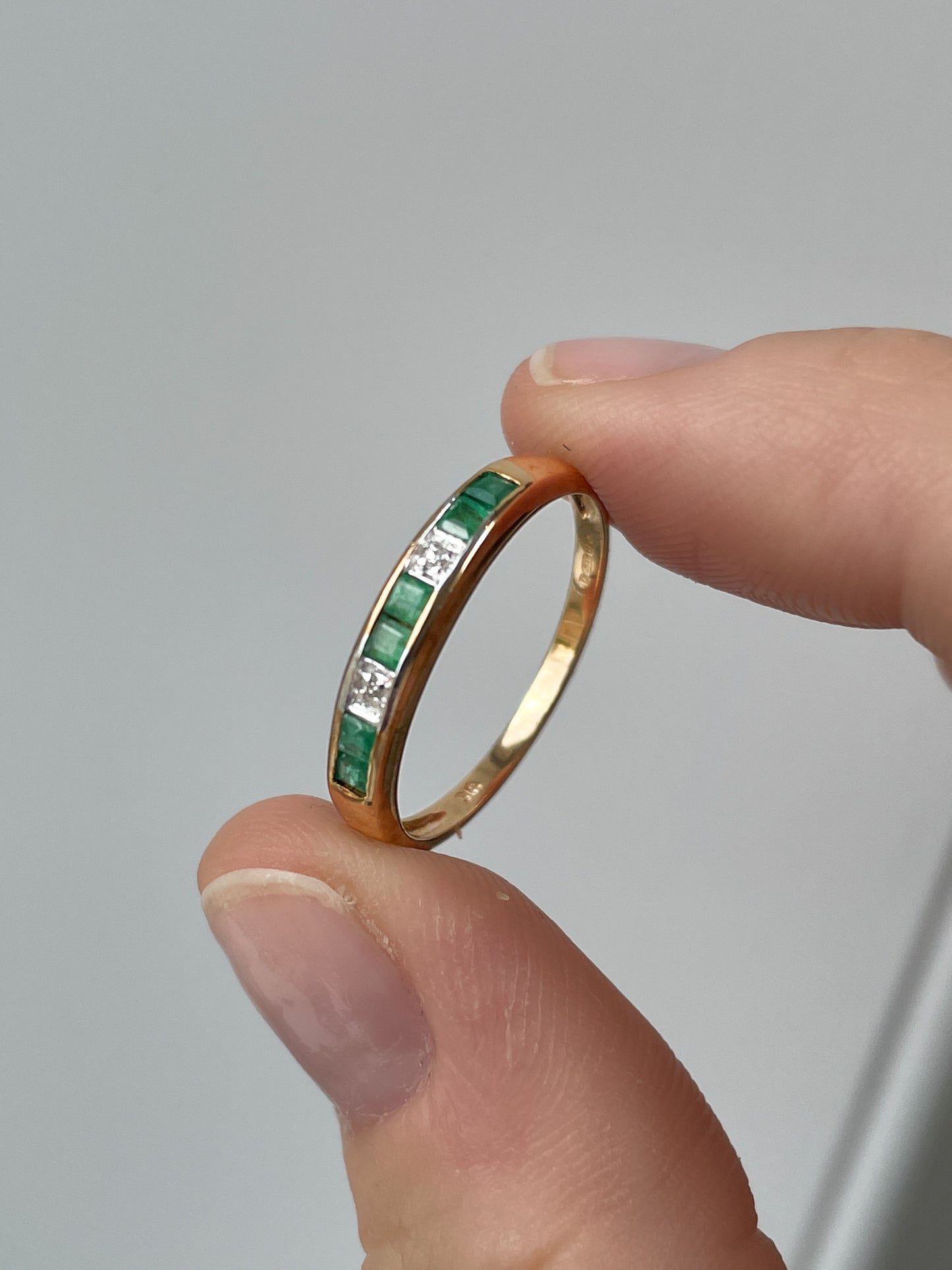 Vintage emerald and diamond half eternity ring
