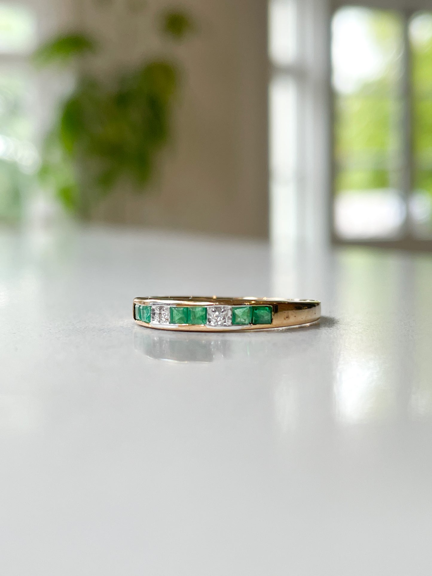 Vintage emerald and diamond half eternity ring