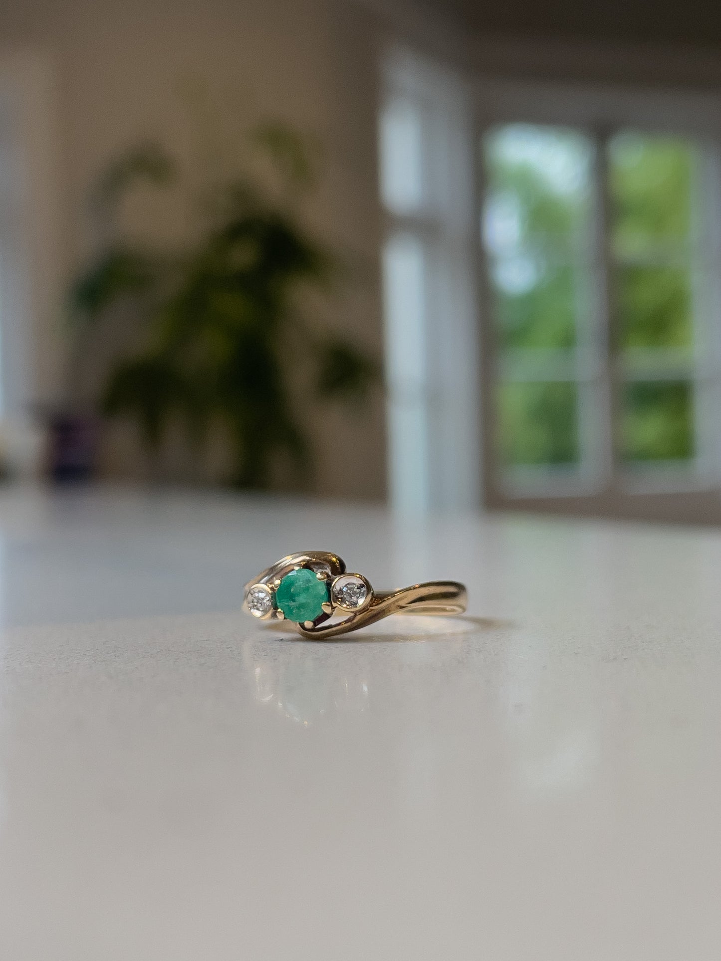A vintage emerald and diamond trilogy ring on 9ct gold