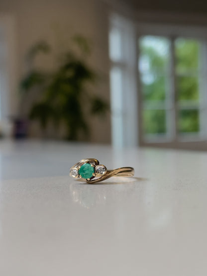 A vintage emerald and diamond trilogy ring on 9ct gold