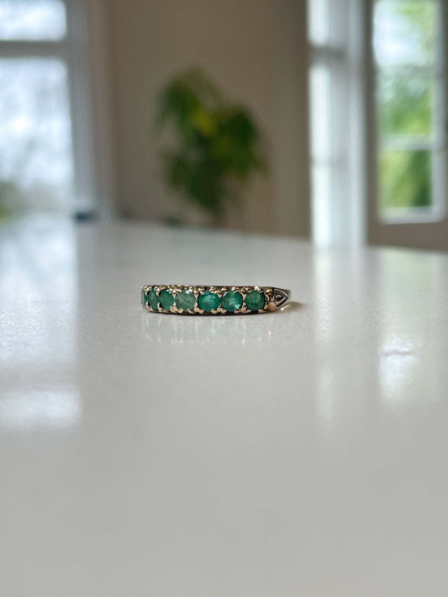 Vintage 7-stone emerald half eternity ring on 9ct gold