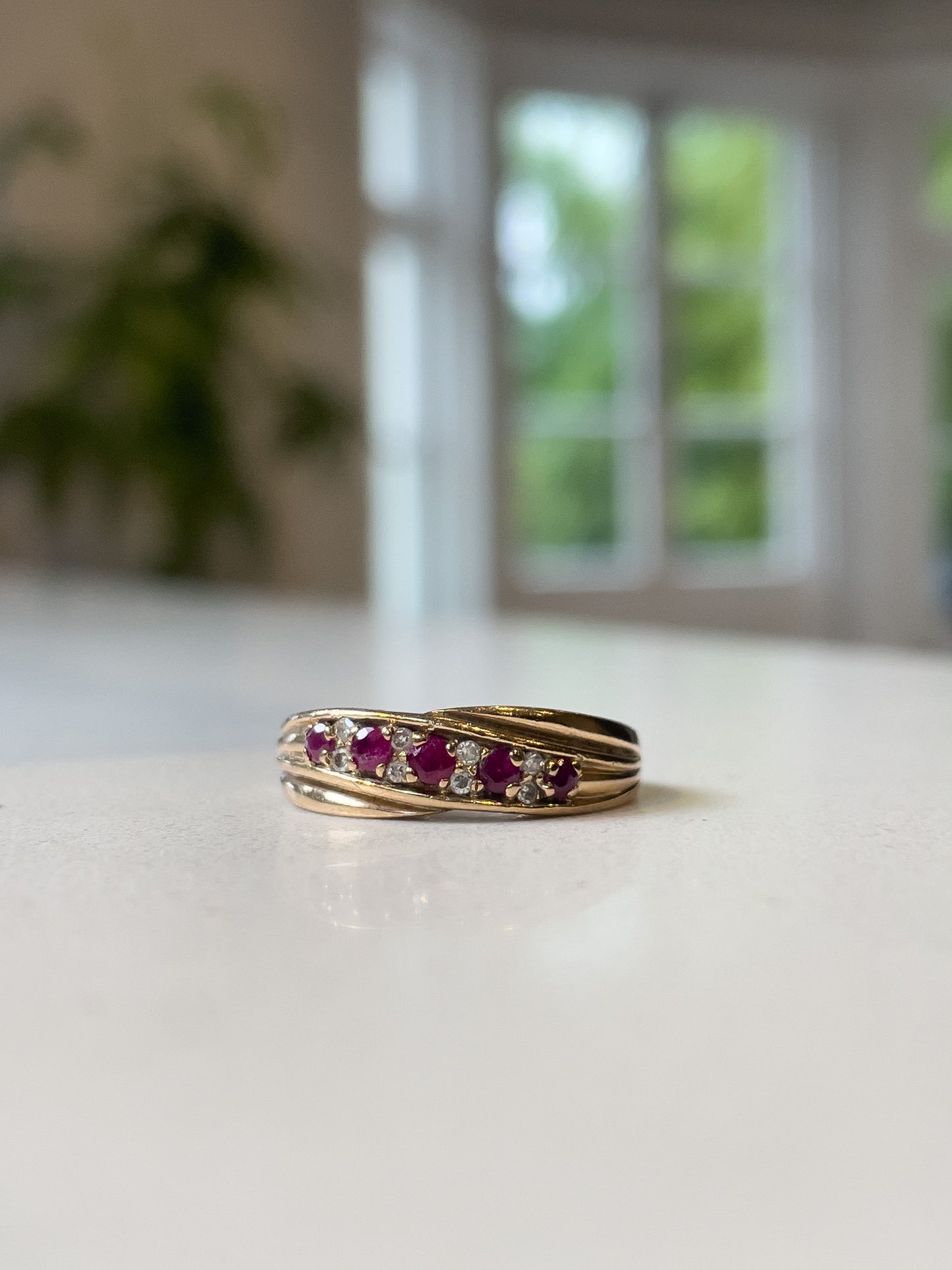 A vintage ruby and diamond crossover band ring on 9ct gold