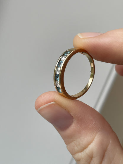 Blue topaz and diamond half eternity ring