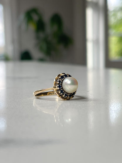 1960s Pearl and sapphire halo ring on 18ct gold
