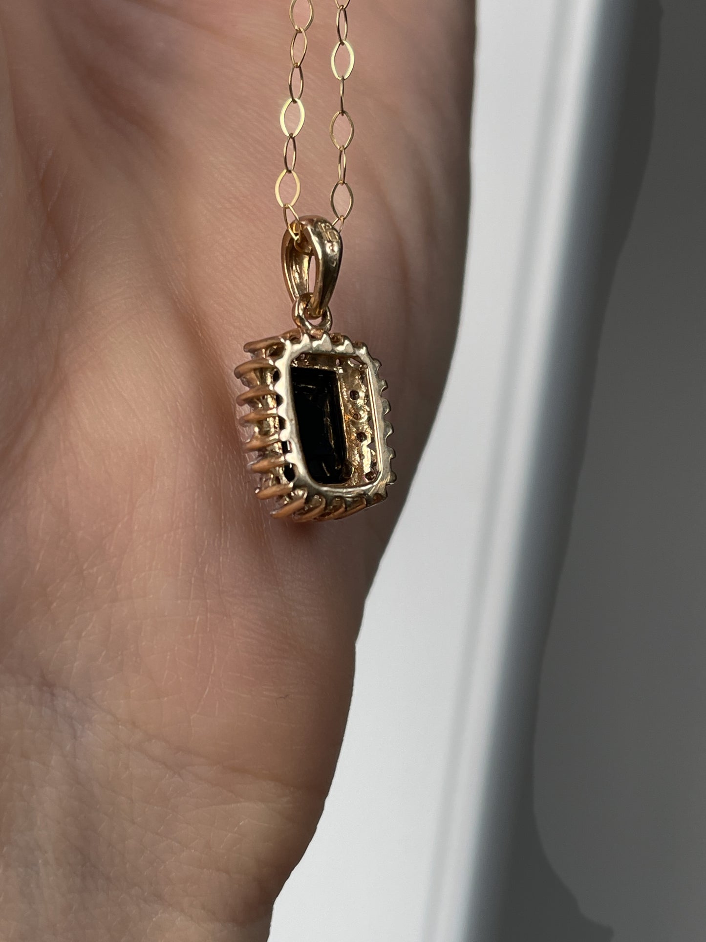 Vintage 1.25ct sapphire and diamond halo pendant with 9ct gold chain