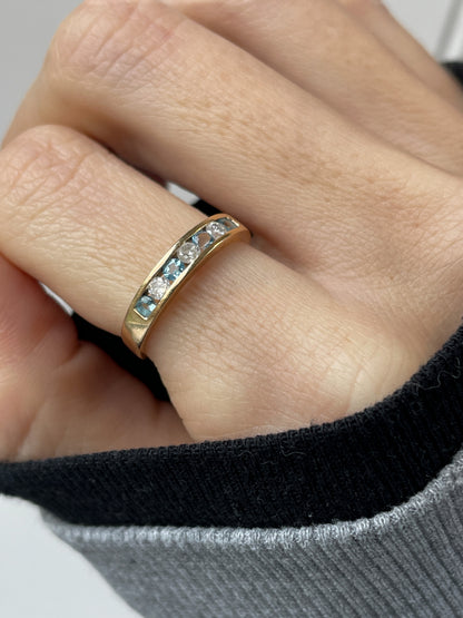 Blue topaz and diamond half eternity ring