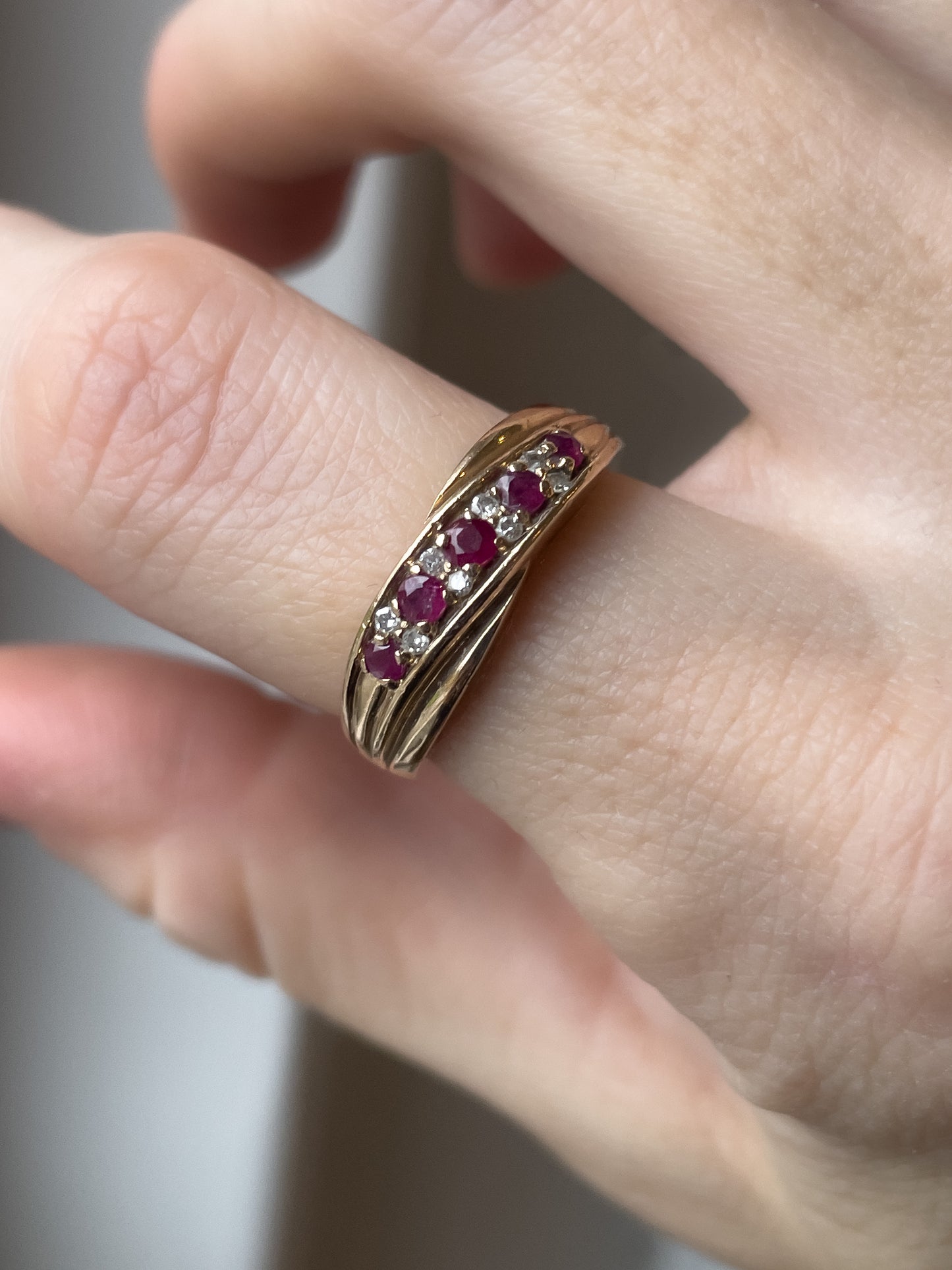 A vintage ruby and diamond crossover band ring on 9ct gold