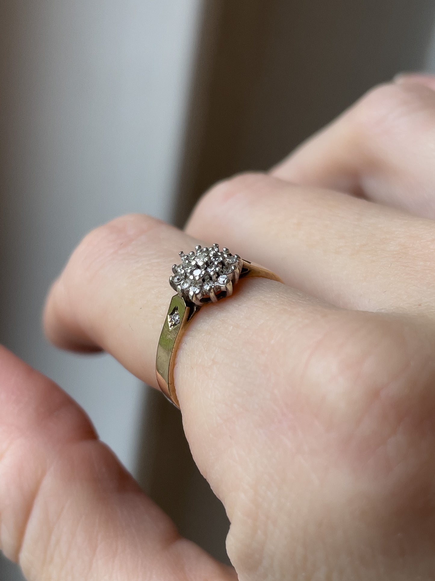 A vintage 9ct gold diamond cluster ring with diamond shoulders