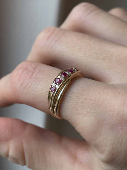 A vintage ruby and diamond crossover band ring on 9ct gold