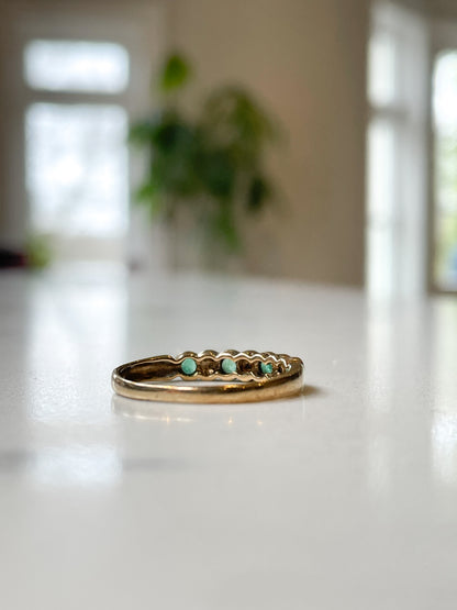 Vintage diamond and emerald 7-stone half eternity ring