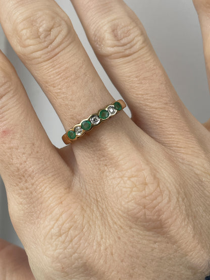 Vintage diamond and emerald 7-stone half eternity ring