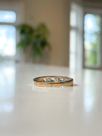 Blue topaz and diamond half eternity ring