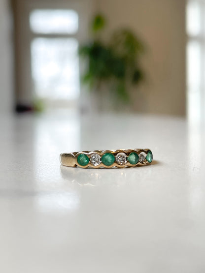 Vintage diamond and emerald 7-stone half eternity ring