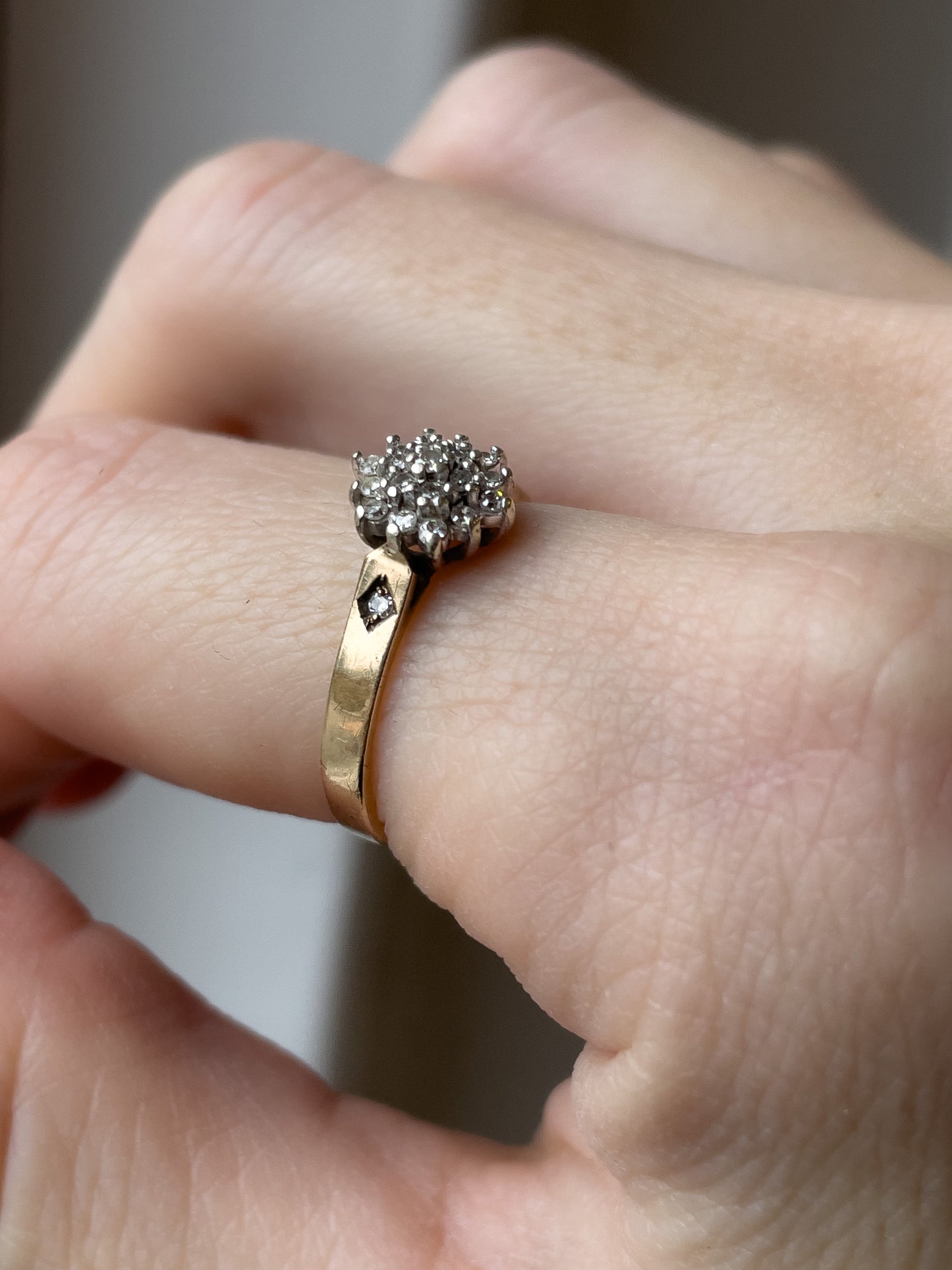 A vintage 9ct gold diamond cluster ring with diamond shoulders