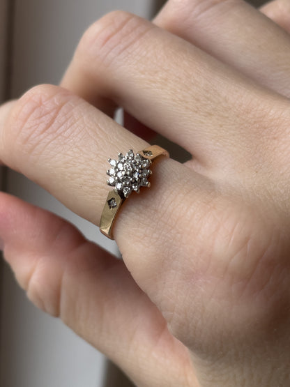 A vintage 9ct gold diamond cluster ring with diamond shoulders