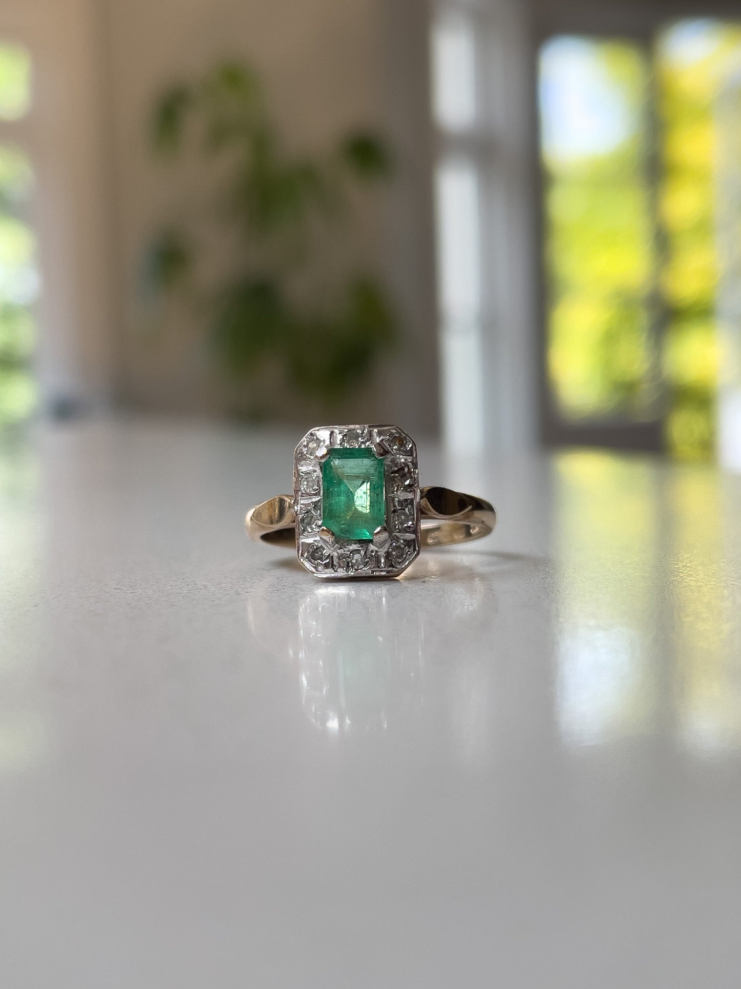 Vintage emerald and diamond halo ring on 9ct gold