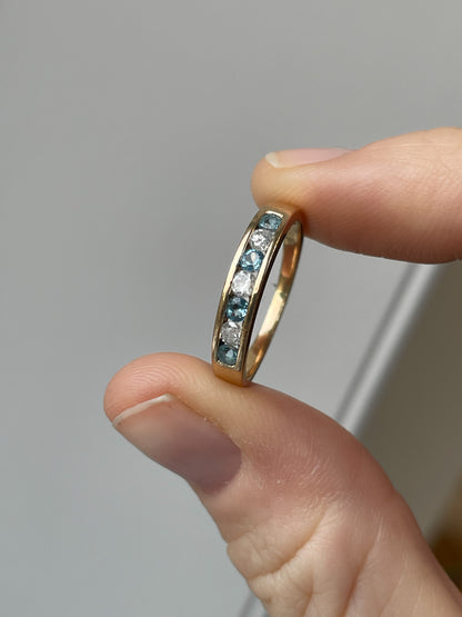 Blue topaz and diamond half eternity ring