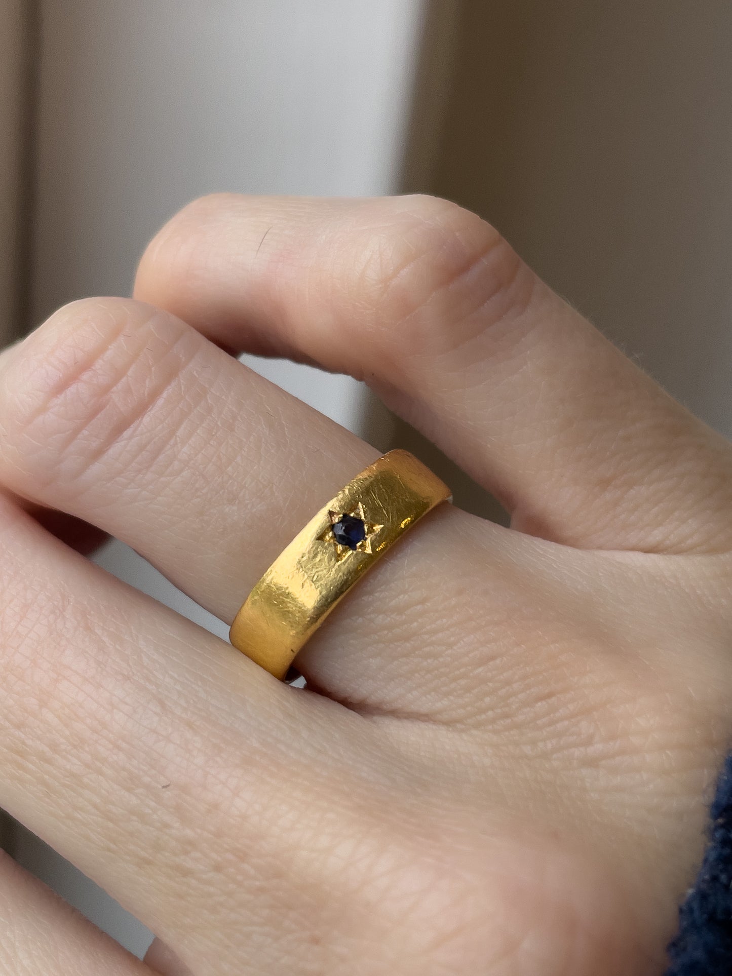 A vintage 22ct gold star set sapphire ring