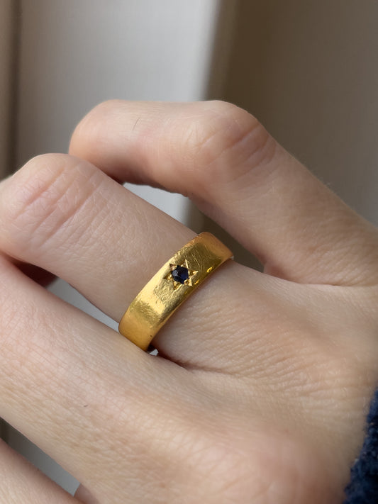 A vintage 22ct gold star set sapphire ring