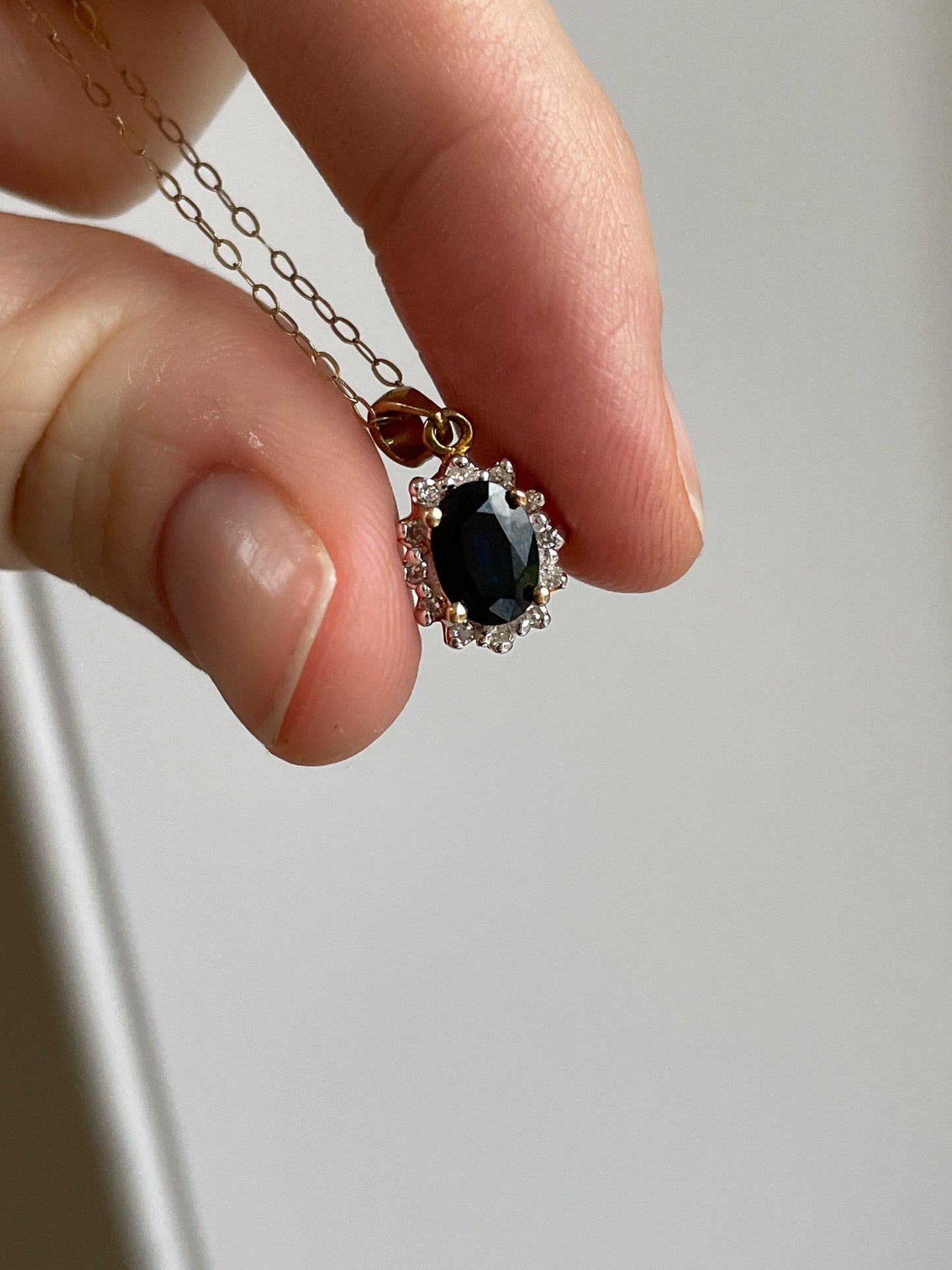 Vintage sapphire and diamond halo cluster pendant and 9ct gold chain