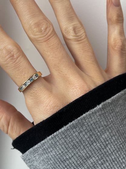 Blue topaz and diamond half eternity ring