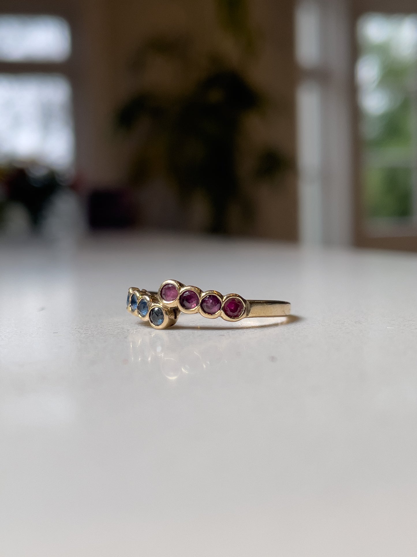 Vintage 8-stone sapphire and ruby bypass ring on 9ct gold
