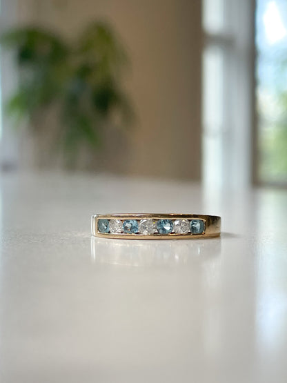 Blue topaz and diamond half eternity ring